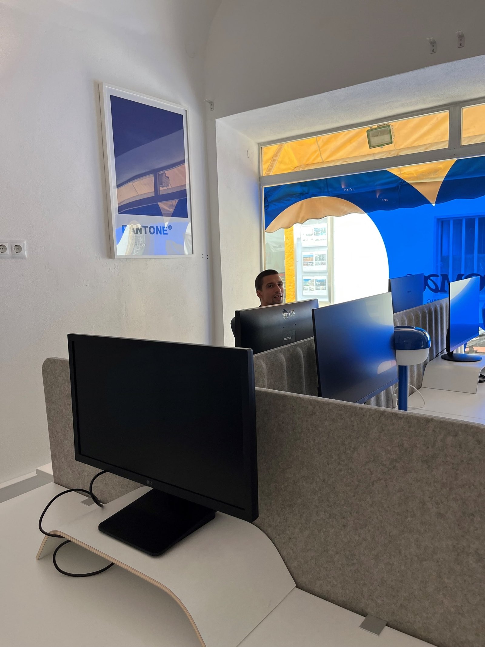 View of POMAR coworking desks with street window in the background